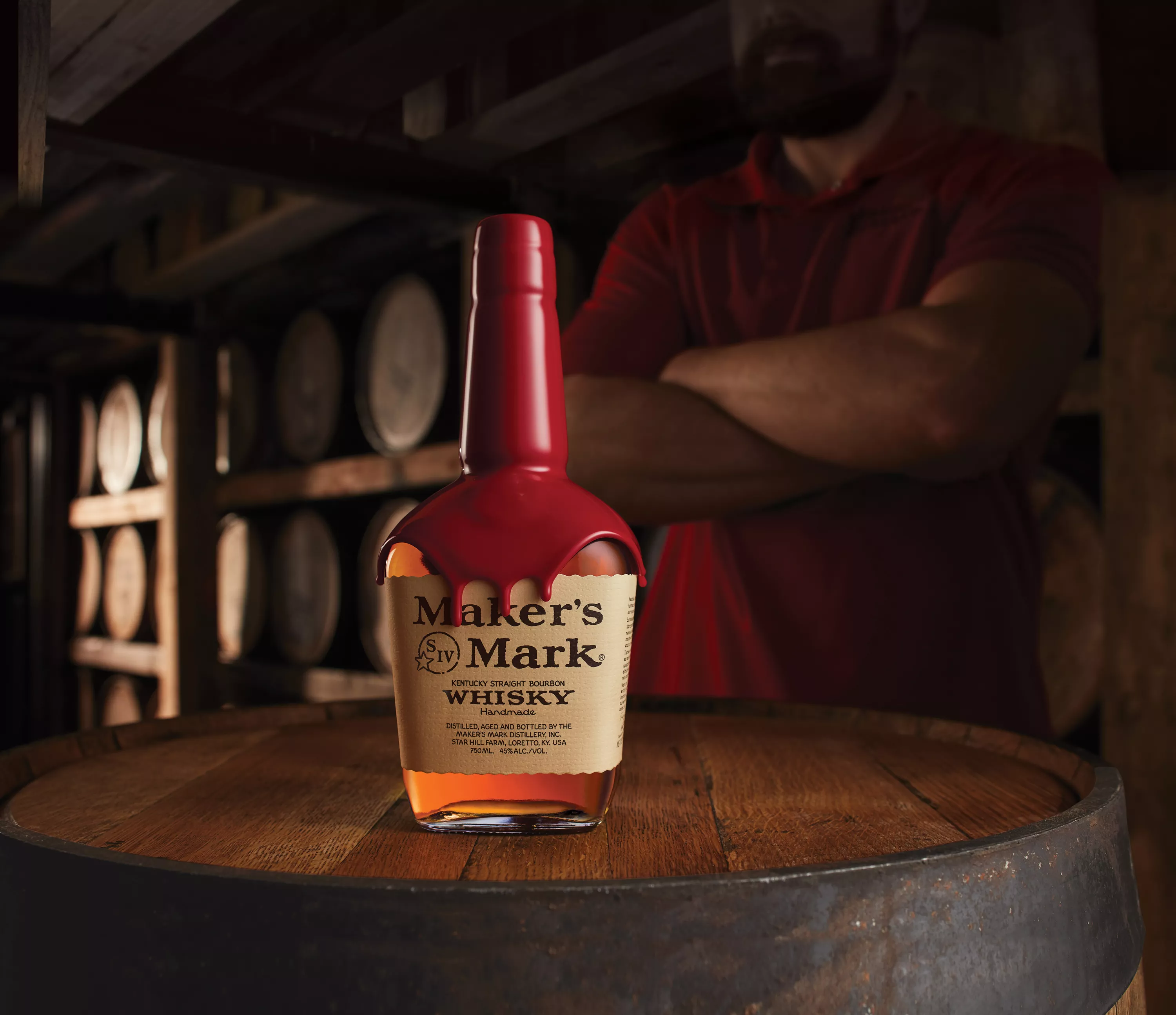Photo of Maker's Mark Kentucky bourbon whisky bottle on top of a barrel