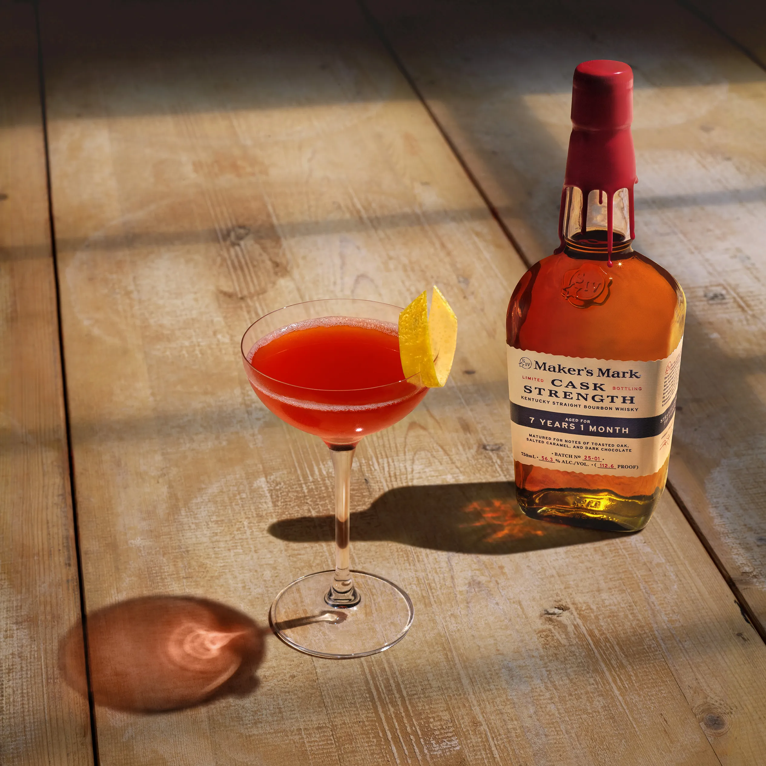 A glass and bottle of paper plane