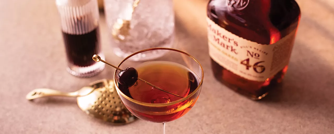 Maker's Mark bourbon whisky Manhattan cocktail with cherry garnish