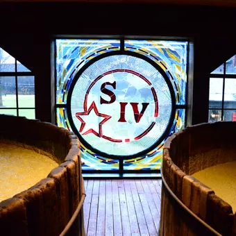 Etched window inside the Maker's Mark distillery featuring the "S IV" logo, which stands for "Samuels Fourth Generation," an allusion to the founding family.